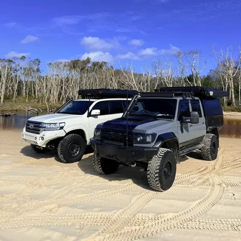 Drewsy's 79 and a 200 Series side by side on the beach.